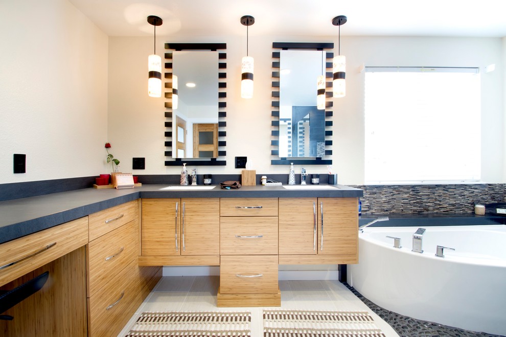 Foto di una stanza da bagno design con vasca ad angolo e top grigio