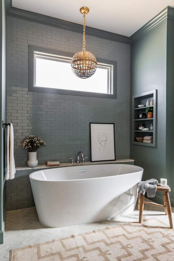 This is an example of a large classic ensuite bathroom in Dallas with a freestanding bath, grey tiles, ceramic tiles, grey walls, brick flooring, beige floors and a wall niche.