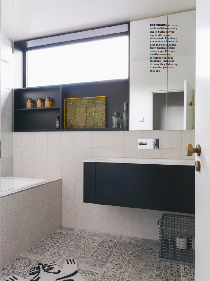 Small bohemian bathroom in Auckland with open cabinets, black cabinets, an alcove bath, a shower/bath combination, beige tiles, ceramic tiles, white walls, ceramic flooring, a built-in sink and an open shower.