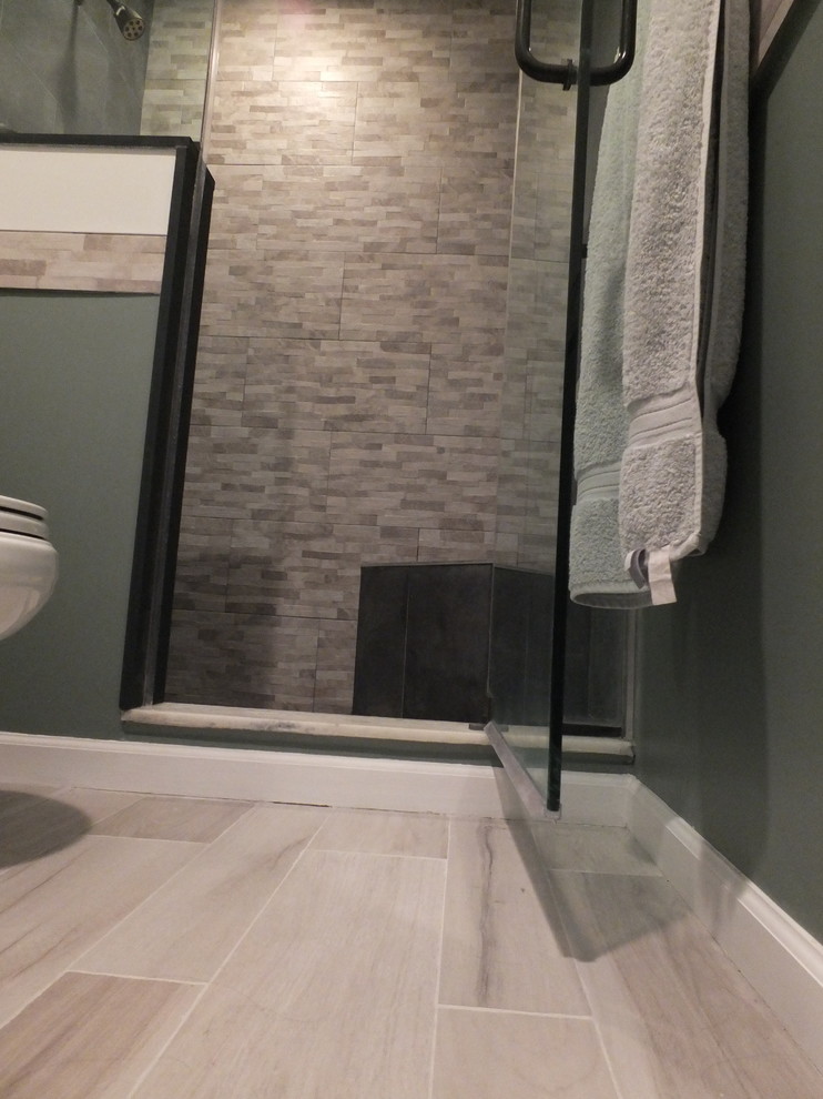 Photo of a small classic shower room bathroom in New York with a submerged sink, dark wood cabinets, quartz worktops, an alcove shower, a two-piece toilet, grey tiles, porcelain tiles, green walls and porcelain flooring.