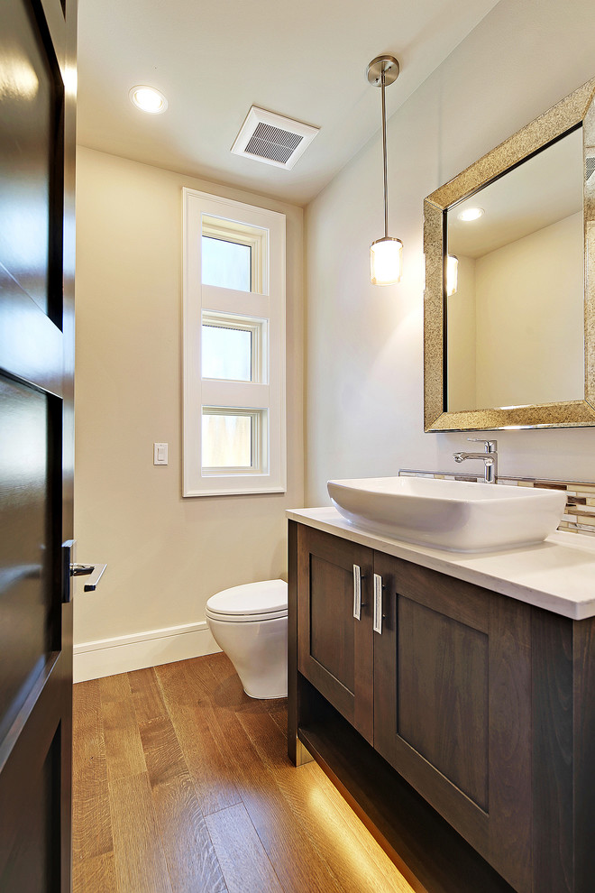 Medium sized contemporary shower room bathroom in Seattle with shaker cabinets, medium wood cabinets, a one-piece toilet, multi-coloured tiles, mosaic tiles, beige walls, medium hardwood flooring, a vessel sink and engineered stone worktops.