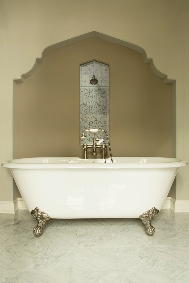 Elegant gray tile marble floor claw-foot bathtub photo in Minneapolis with marble countertops and a two-piece toilet