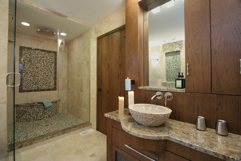 Immagine di una stanza da bagno design con lavabo a bacinella, ante lisce, doccia alcova, piastrelle beige e ante in legno bruno
