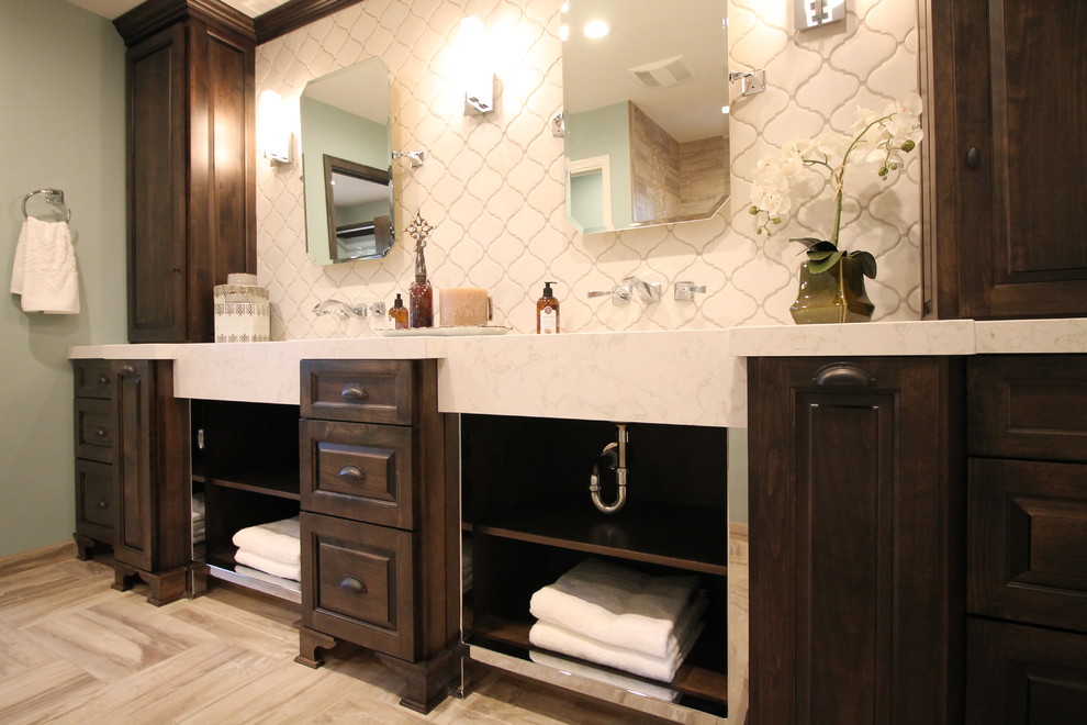 This is an example of a large classic ensuite bathroom in Sacramento with a submerged sink, raised-panel cabinets, dark wood cabinets, engineered stone worktops, a walk-in shower, a two-piece toilet, beige tiles, porcelain tiles, blue walls and porcelain flooring.