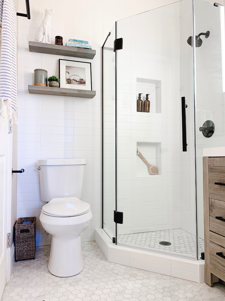 Inspiration for a small modern master white tile and subway tile porcelain tile and gray floor corner shower remodel in Dallas with flat-panel cabinets, light wood cabinets, a one-piece toilet, white walls, a drop-in sink, marble countertops, a hinged shower door and white countertops
