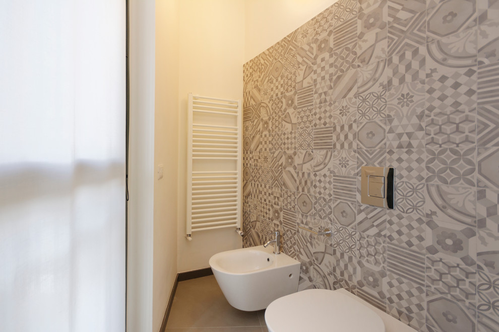 Example of a mid-sized classic 3/4 gray tile and ceramic tile concrete floor bathroom design in Milan with a wall-mount toilet and white walls