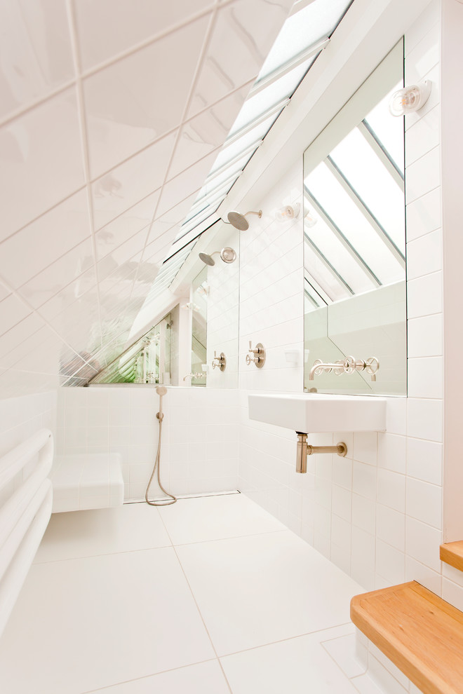 Inspiration for a small contemporary bathroom in Oxfordshire with a wall mounted toilet, white tiles, ceramic tiles, white walls, porcelain flooring, a wall-mounted sink and white floors.