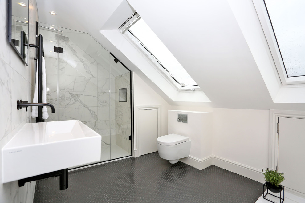 Design ideas for a contemporary bathroom in London with an alcove shower, a wall mounted toilet, white tiles, white walls, a wall-mounted sink, grey floors and a hinged door.