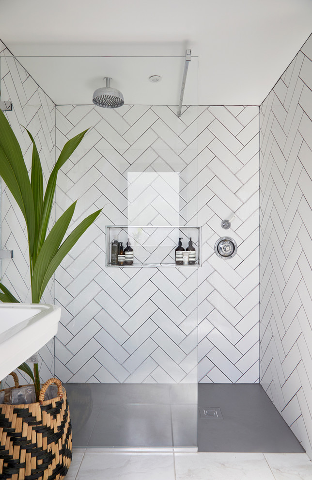 This is an example of a small scandi shower room bathroom in London with white tiles, ceramic tiles and an open shower.
