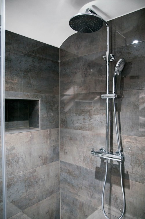 Example of a small trendy master gray tile and ceramic tile porcelain tile and gray floor freestanding bathtub design in Other with brown cabinets, white walls, a vessel sink, a hinged shower door and brown countertops