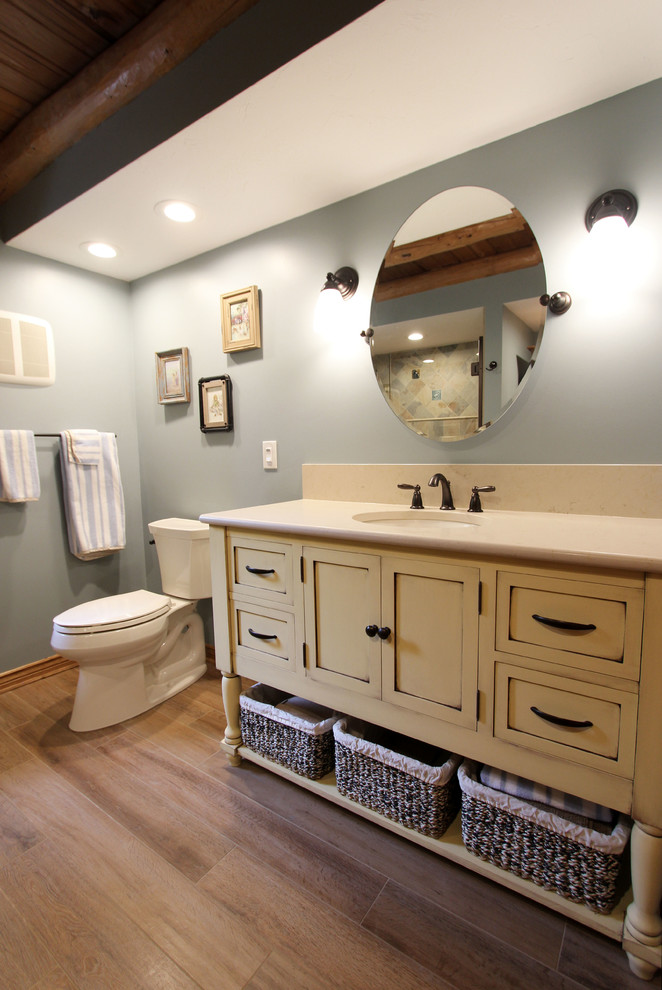 Esempio di una stanza da bagno padronale rustica di medie dimensioni con doccia ad angolo, piastrelle beige, piastrelle in gres porcellanato, pareti blu, pavimento in gres porcellanato, lavabo sottopiano e pavimento beige