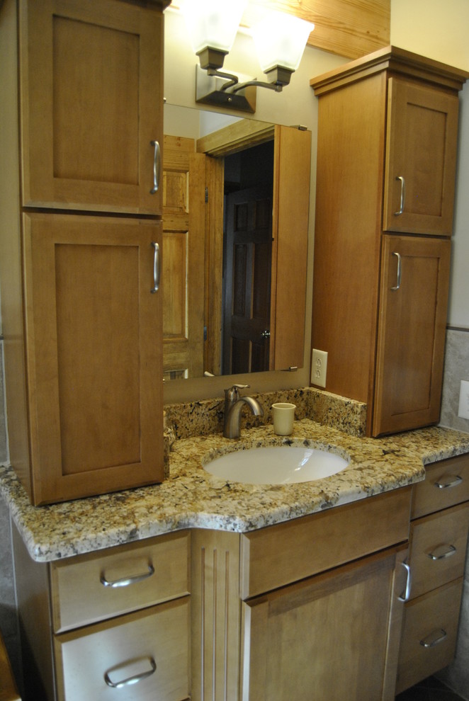 Example of a small mountain style master beige tile and porcelain tile porcelain tile bathroom design in Philadelphia with an undermount sink, shaker cabinets, medium tone wood cabinets, granite countertops, a two-piece toilet and beige walls