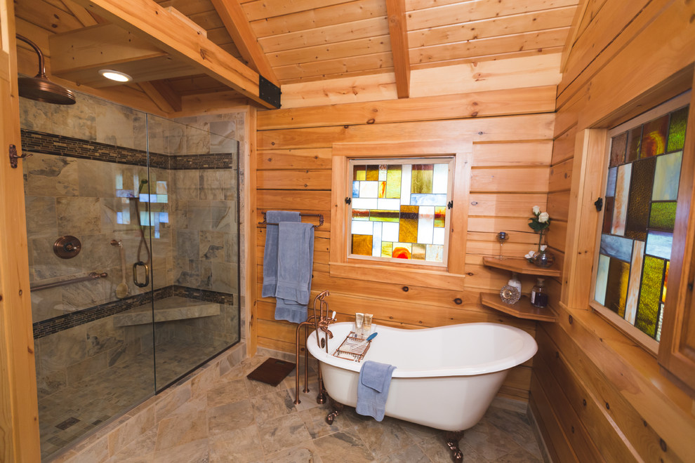 Inspiration for a medium sized rustic ensuite bathroom in Nashville with medium wood cabinets, a claw-foot bath, an alcove shower, grey tiles, porcelain tiles, porcelain flooring, a built-in sink and a one-piece toilet.