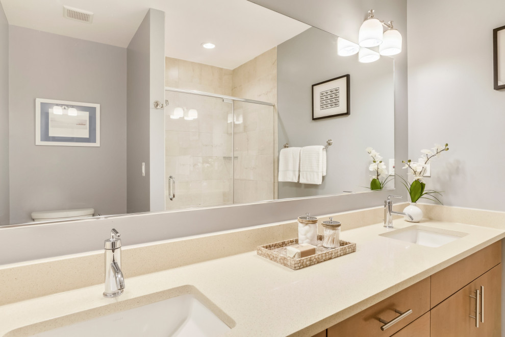 Exempel på ett mellanstort klassiskt beige beige badrum med dusch, med släta luckor, skåp i mellenmörkt trä, en hörndusch, beige kakel, grå väggar, ett undermonterad handfat och dusch med gångjärnsdörr