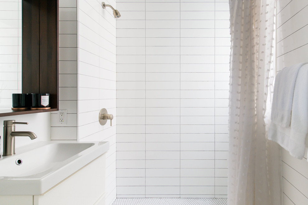 Bathroom - small modern master white tile and ceramic tile ceramic tile and white floor bathroom idea in Chicago with flat-panel cabinets, white cabinets, a one-piece toilet, white walls, a wall-mount sink and white countertops