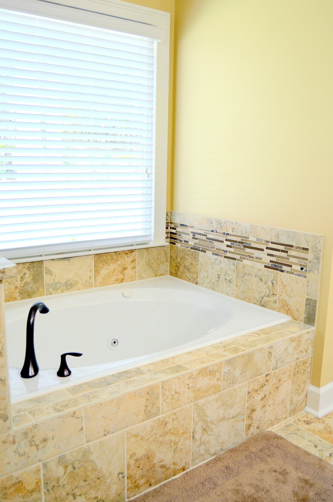 Example of a mid-sized transitional master beige tile and porcelain tile porcelain tile bathroom design in Atlanta with a drop-in sink, flat-panel cabinets, medium tone wood cabinets, granite countertops, a one-piece toilet and yellow walls
