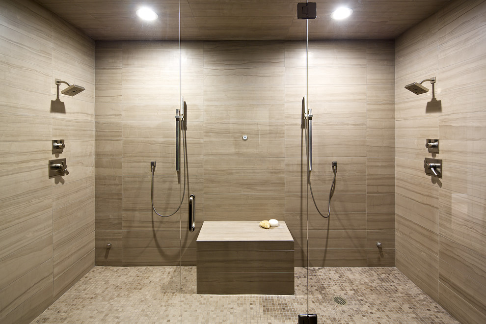 This is an example of a large contemporary ensuite bathroom in Denver with flat-panel cabinets, dark wood cabinets, granite worktops, a double shower, a one-piece toilet, beige tiles, stone tiles, grey walls and ceramic flooring.