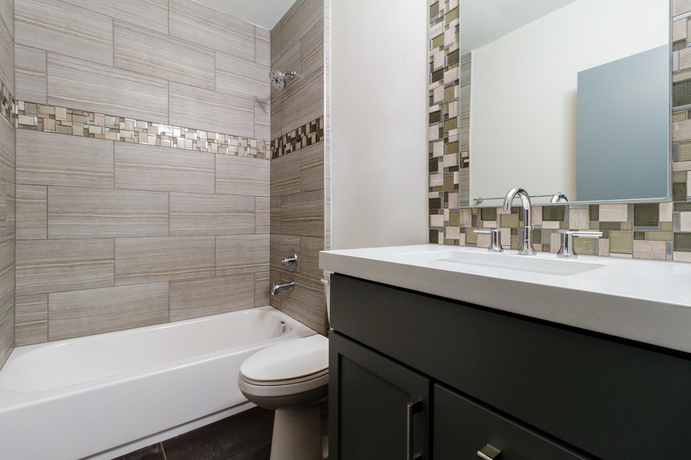 Photo of a small industrial bathroom in Denver with a submerged sink, shaker cabinets, dark wood cabinets, quartz worktops, an alcove bath, a walk-in shower, a two-piece toilet, beige tiles, ceramic tiles, beige walls and ceramic flooring.