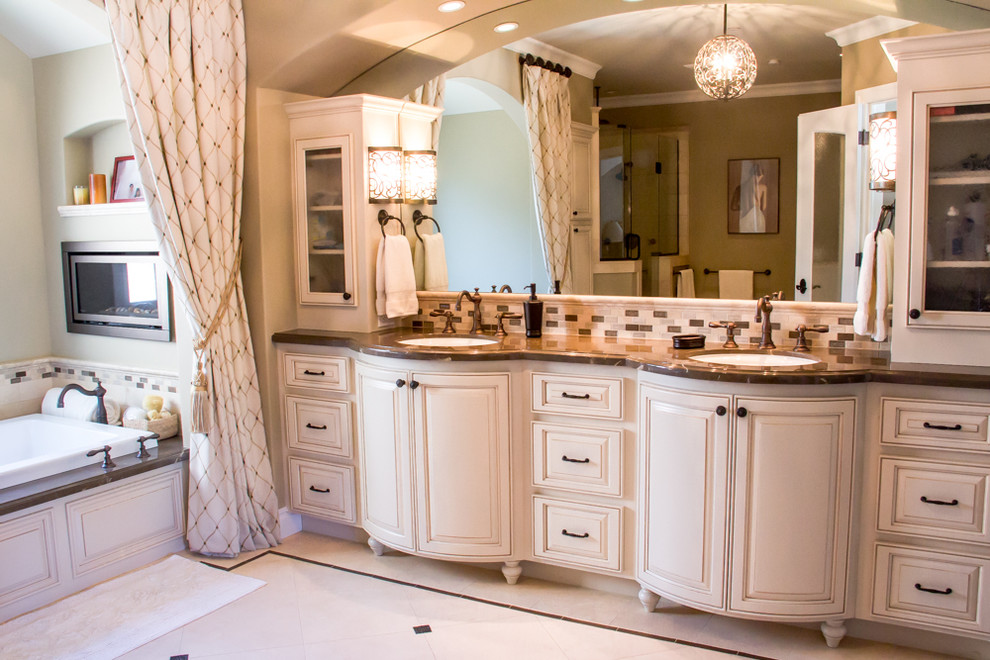 This is an example of a classic bathroom in San Francisco with beige cabinets, a corner shower, beige walls, lino flooring, a submerged sink, soapstone worktops, beige floors and a hinged door.