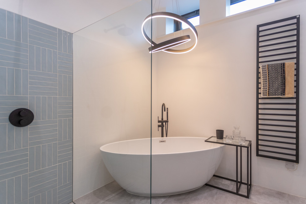 Идея дизайна: большая главная ванная комната в современном стиле с отдельно стоящей ванной, серой плиткой, керамической плиткой, белыми стенами, полом из керамогранита и серым полом