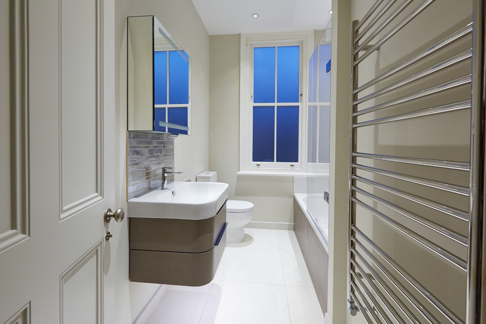 Small contemporary family bathroom in London with flat-panel cabinets, brown cabinets, a freestanding bath, a walk-in shower, a two-piece toilet, multi-coloured tiles, ceramic tiles, multi-coloured walls, ceramic flooring, a submerged sink and quartz worktops.