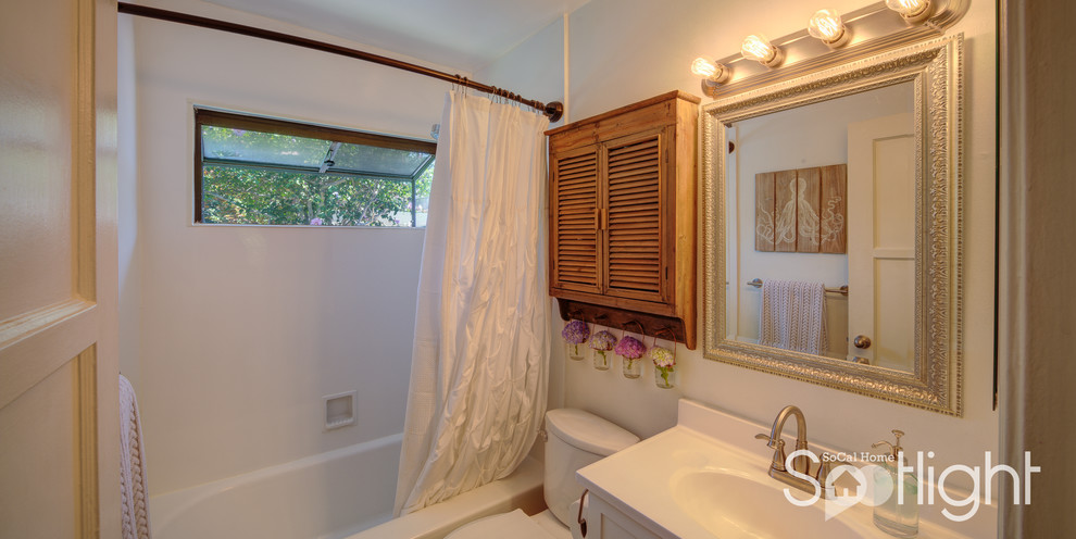 Small mid-century modern 3/4 white tile bathroom photo in Los Angeles with recessed-panel cabinets, white cabinets, a two-piece toilet, white walls and an integrated sink