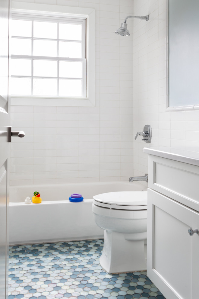 Large transitional kids' white tile and ceramic tile mosaic tile floor bathroom photo in New York with an undermount sink, shaker cabinets, white cabinets, quartzite countertops, a one-piece toilet and blue walls