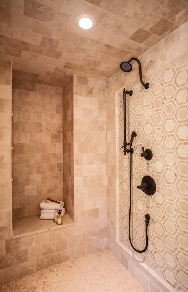 Inspiration for a large classic ensuite bathroom in Minneapolis with flat-panel cabinets, medium wood cabinets, a freestanding bath, an alcove shower, a one-piece toilet, beige tiles, stone tiles, beige walls, travertine flooring, a submerged sink and marble worktops.