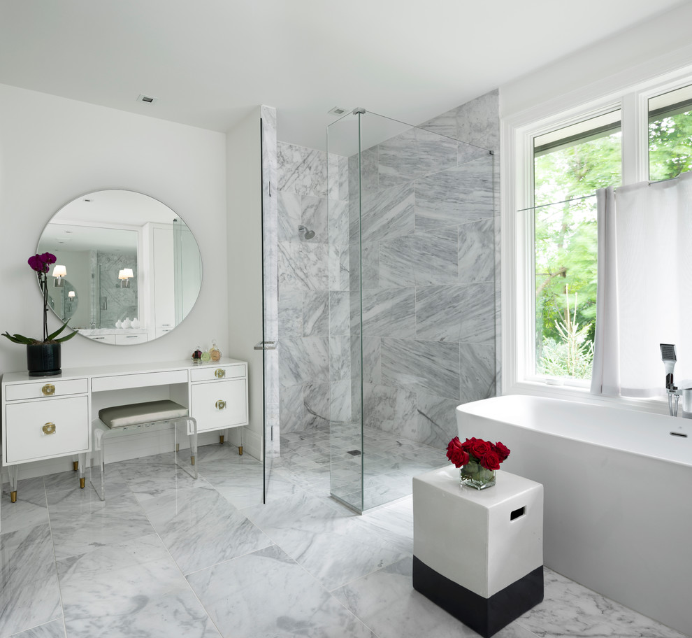 Пример оригинального дизайна: главная ванная комната в стиле неоклассика (современная классика) с белыми фасадами, отдельно стоящей ванной, душем без бортиков, мраморной плиткой, белыми стенами, мраморным полом, душем с распашными дверями, окном и плоскими фасадами