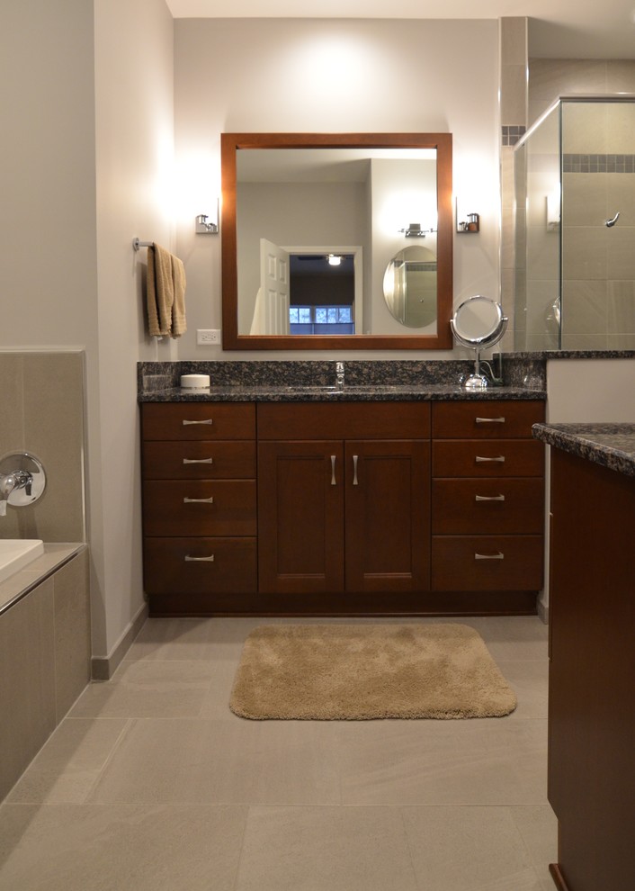 Small transitional gray tile and porcelain tile porcelain tile bathroom photo in Other with flat-panel cabinets, medium tone wood cabinets, a two-piece toilet, gray walls, an undermount sink and granite countertops