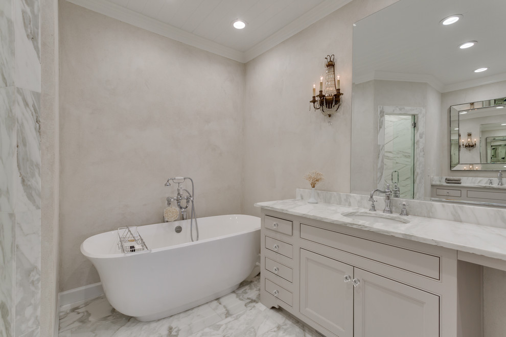 This is an example of a medium sized victorian ensuite bathroom in Dallas with beaded cabinets, white cabinets, a freestanding bath, a corner shower, a two-piece toilet, white tiles, marble tiles, white walls, marble flooring, a submerged sink, marble worktops, white floors and a hinged door.