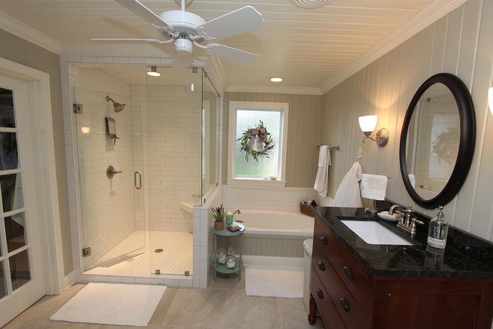 Bathroom - mid-sized traditional master white tile and subway tile gray floor bathroom idea in New Orleans with furniture-like cabinets, dark wood cabinets, a one-piece toilet, an undermount sink, a hinged shower door and gray walls