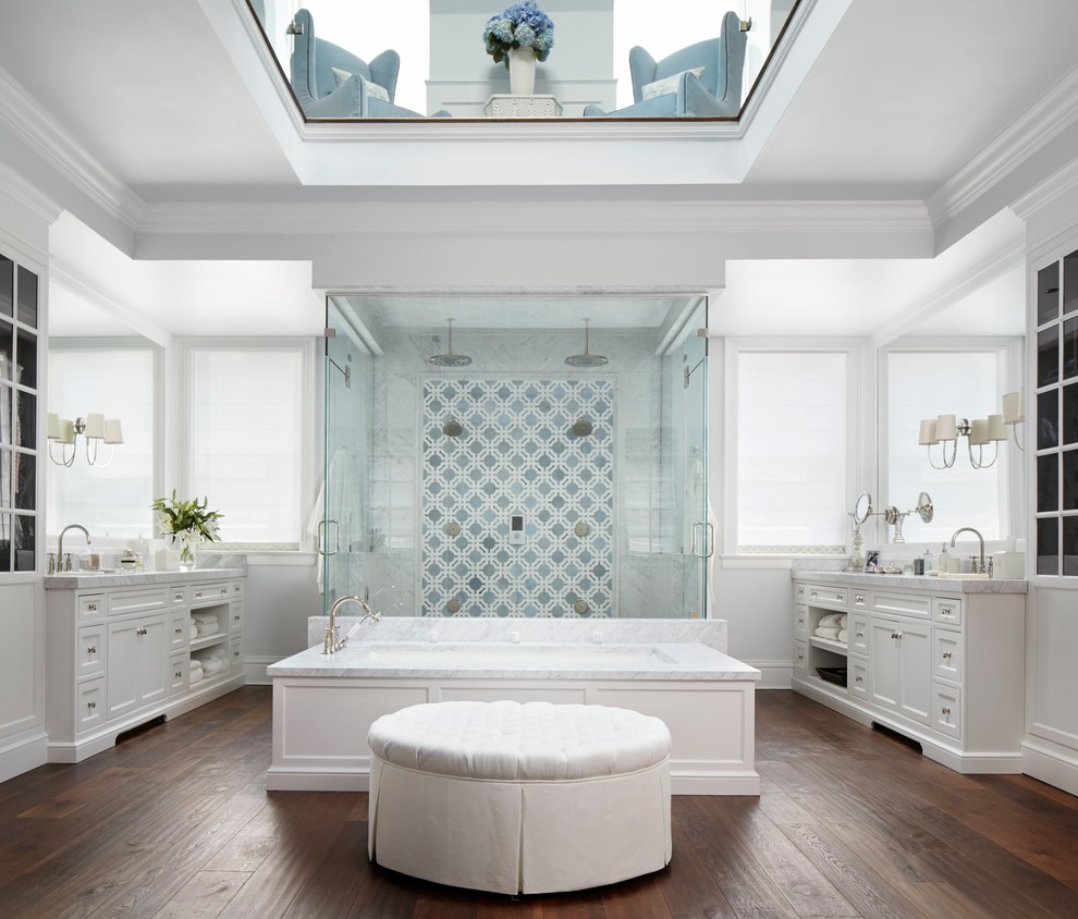 Large traditional ensuite bathroom in Chicago with white cabinets, a submerged bath, a double shower, white walls, dark hardwood flooring, brown floors, a hinged door, shaker cabinets and multi-coloured tiles.