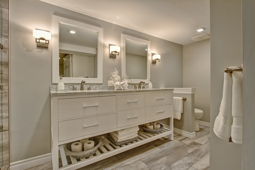 Photo of a medium sized nautical bathroom in Toronto with freestanding cabinets, white cabinets, a double shower, grey tiles, porcelain tiles, grey walls, porcelain flooring, a submerged sink and marble worktops.