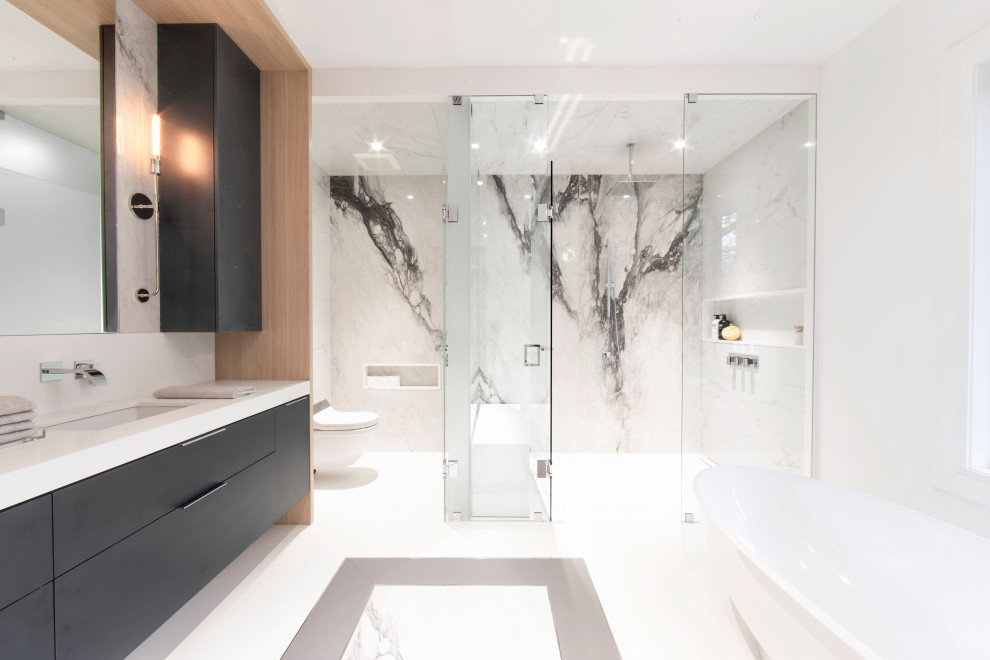 Example of a large trendy master white tile and porcelain tile porcelain tile and white floor bathroom design in Toronto with flat-panel cabinets, blue cabinets, a wall-mount toilet, white walls, an undermount sink, quartz countertops, a hinged shower door, white countertops and a niche