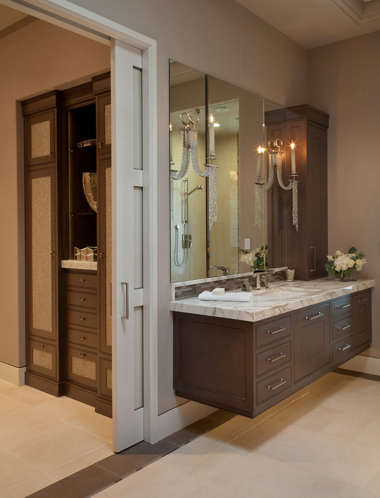This is an example of a large classic ensuite bathroom in San Francisco with beaded cabinets, dark wood cabinets and a submerged sink.
