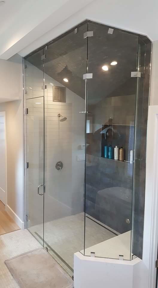 Photo of a contemporary bathroom in San Francisco with an alcove shower, white tiles, glass tiles, beige walls, mosaic tile flooring, white floors and a hinged door.