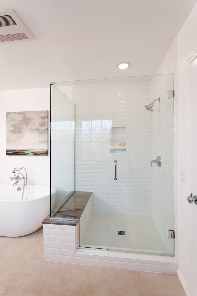 Beach style bathroom in Los Angeles with a freestanding bath, a corner shower, white tiles, metro tiles and white walls.