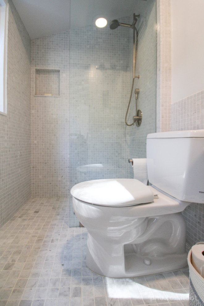 Medium sized traditional shower room bathroom in Los Angeles with a built-in shower, a two-piece toilet, cement tiles, cement flooring, a console sink, grey floors, an open shower, a wall niche, a single sink, a vaulted ceiling, wainscoting, grey tiles and grey walls.