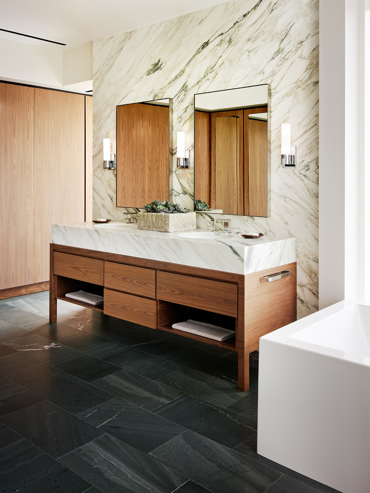 На фото: большая главная ванная комната в современном стиле с врезной раковиной, фасадами цвета дерева среднего тона, мраморной столешницей и полом из сланца