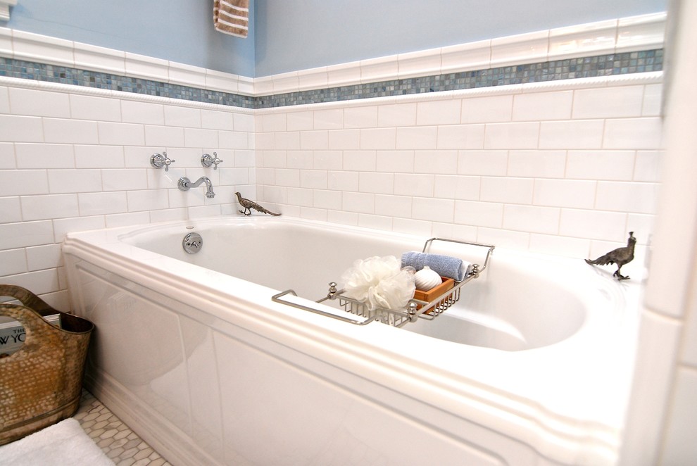 Photo of a small contemporary ensuite bathroom in Los Angeles with a submerged sink, recessed-panel cabinets, white cabinets, marble worktops, a corner bath, a corner shower, a one-piece toilet, blue tiles, metro tiles, blue walls and marble flooring.