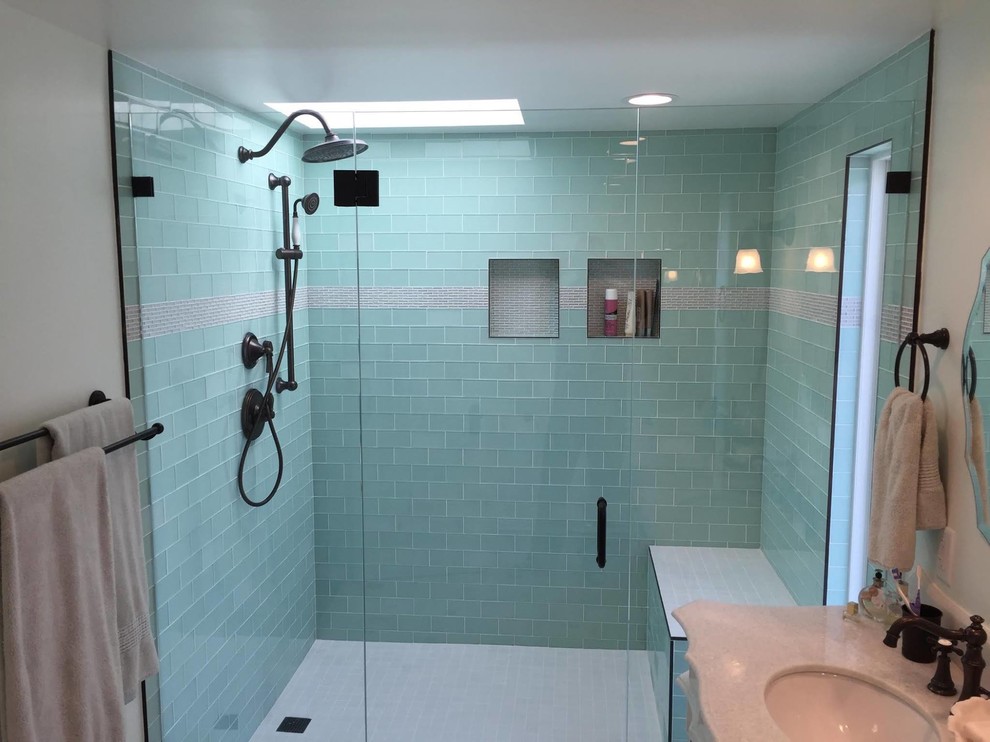Example of a mid-sized beach style 3/4 gray tile and matchstick tile porcelain tile alcove shower design in Los Angeles with recessed-panel cabinets, white cabinets, beige walls, an undermount sink and granite countertops