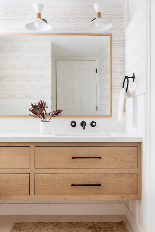 This is an example of a small country bathroom in San Francisco with light wood cabinets, a two-piece toilet, white walls, cement flooring, a submerged sink, engineered stone worktops, white floors, white worktops, a single sink, a floating vanity unit, wallpapered walls and flat-panel cabinets.