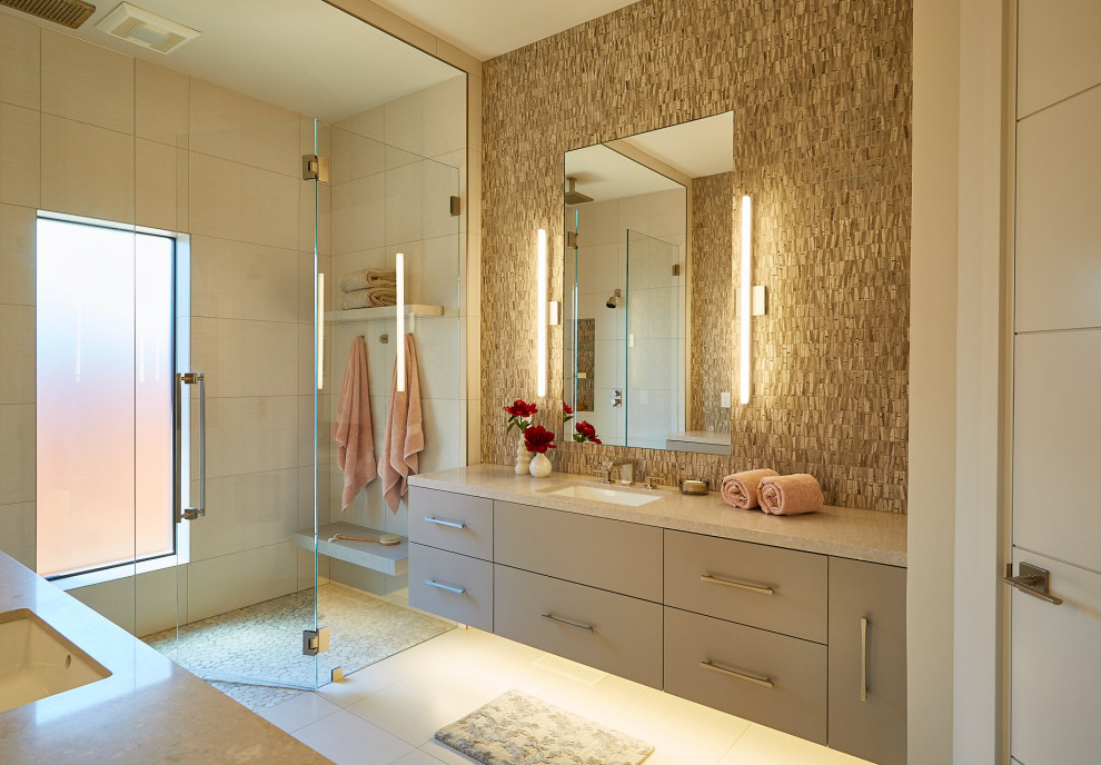 Inspiration for a large contemporary master beige tile and mosaic tile porcelain tile and beige floor walk-in shower remodel in San Francisco with flat-panel cabinets, beige cabinets, an undermount sink, quartz countertops, a hinged shower door and beige countertops