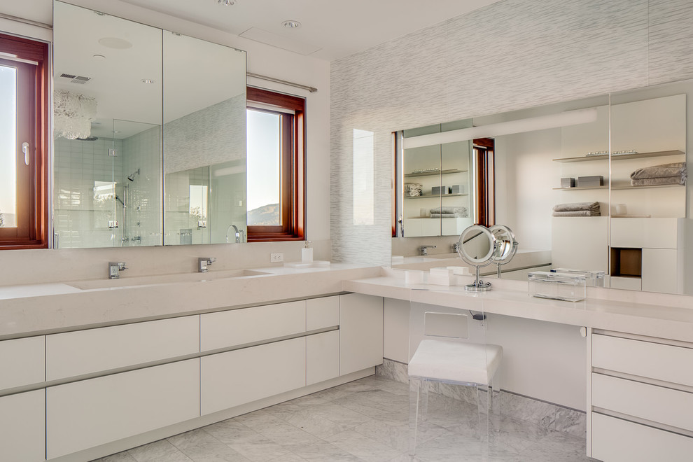 Photo of a large contemporary ensuite bathroom in San Francisco with solid surface worktops, stone tiles, white walls, marble flooring, white floors, flat-panel cabinets, white cabinets, an alcove shower, an integrated sink and a hinged door.