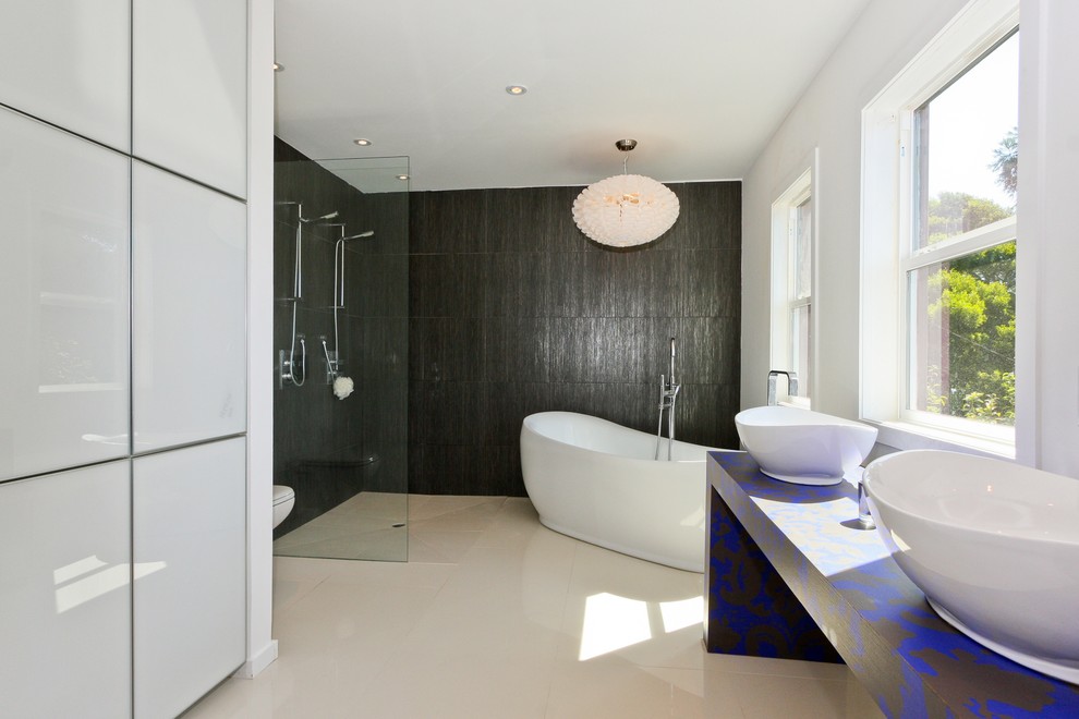 Example of a trendy black tile bathroom design in San Francisco with a vessel sink