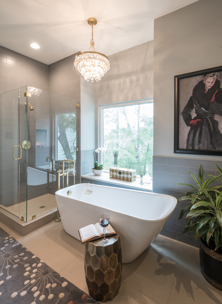 Inspiration for a large eclectic ensuite bathroom in Austin with flat-panel cabinets, grey cabinets, a freestanding bath, a corner shower, a two-piece toilet, grey tiles, ceramic tiles, grey walls, ceramic flooring, a built-in sink, granite worktops, beige floors and a hinged door.