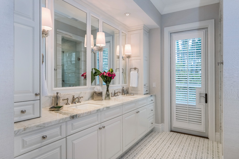 Large elegant master mosaic tile floor and white floor bathroom photo in Other with raised-panel cabinets, an undermount tub, a one-piece toilet, gray walls, an undermount sink, marble countertops, a hinged shower door, white countertops and purple cabinets