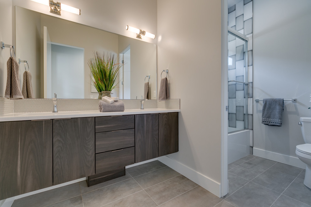 Inspiration for a large modern master blue tile, gray tile, white tile and ceramic tile porcelain tile and gray floor bathroom remodel in Boise with flat-panel cabinets, medium tone wood cabinets, a two-piece toilet, gray walls, an undermount sink, quartz countertops and white countertops