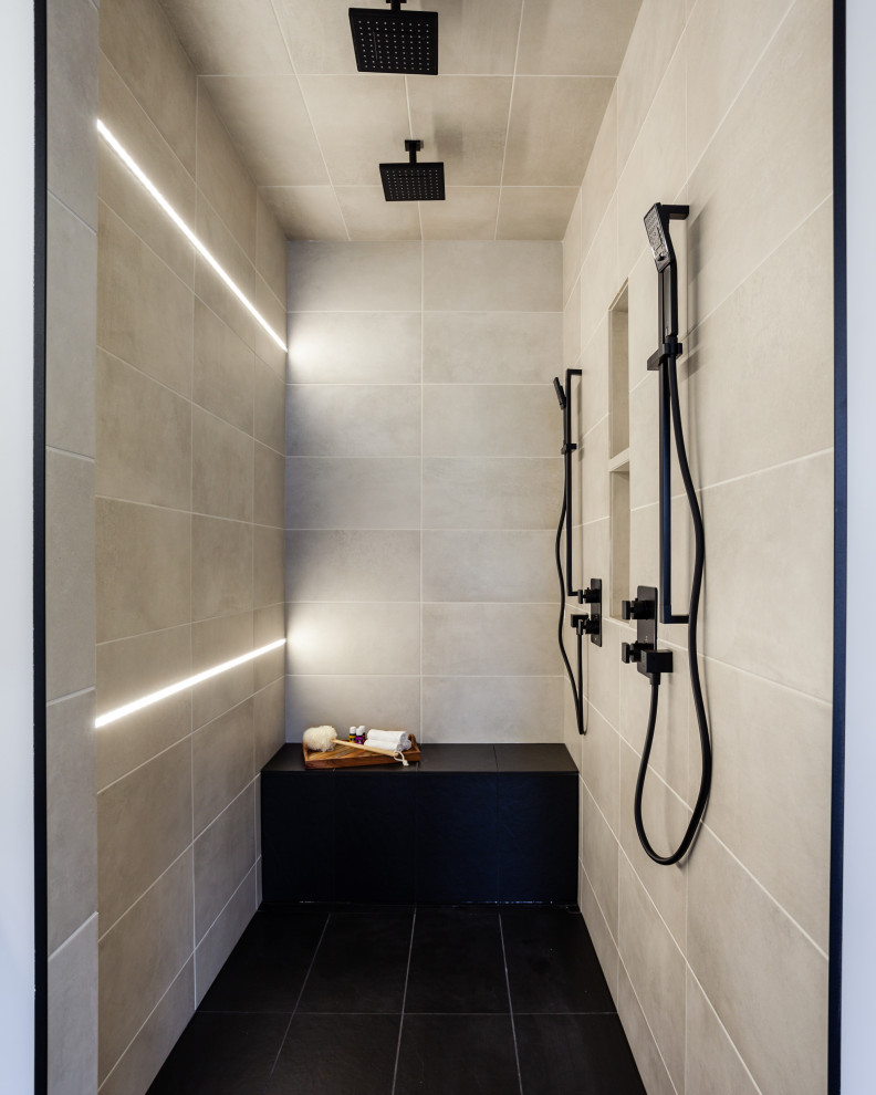Photo of a large contemporary ensuite bathroom in Other with flat-panel cabinets, white cabinets, a freestanding bath, a walk-in shower, a two-piece toilet, grey tiles, ceramic tiles, grey walls, ceramic flooring, a submerged sink, engineered stone worktops, black floors, an open shower, white worktops, a shower bench, double sinks and a built in vanity unit.